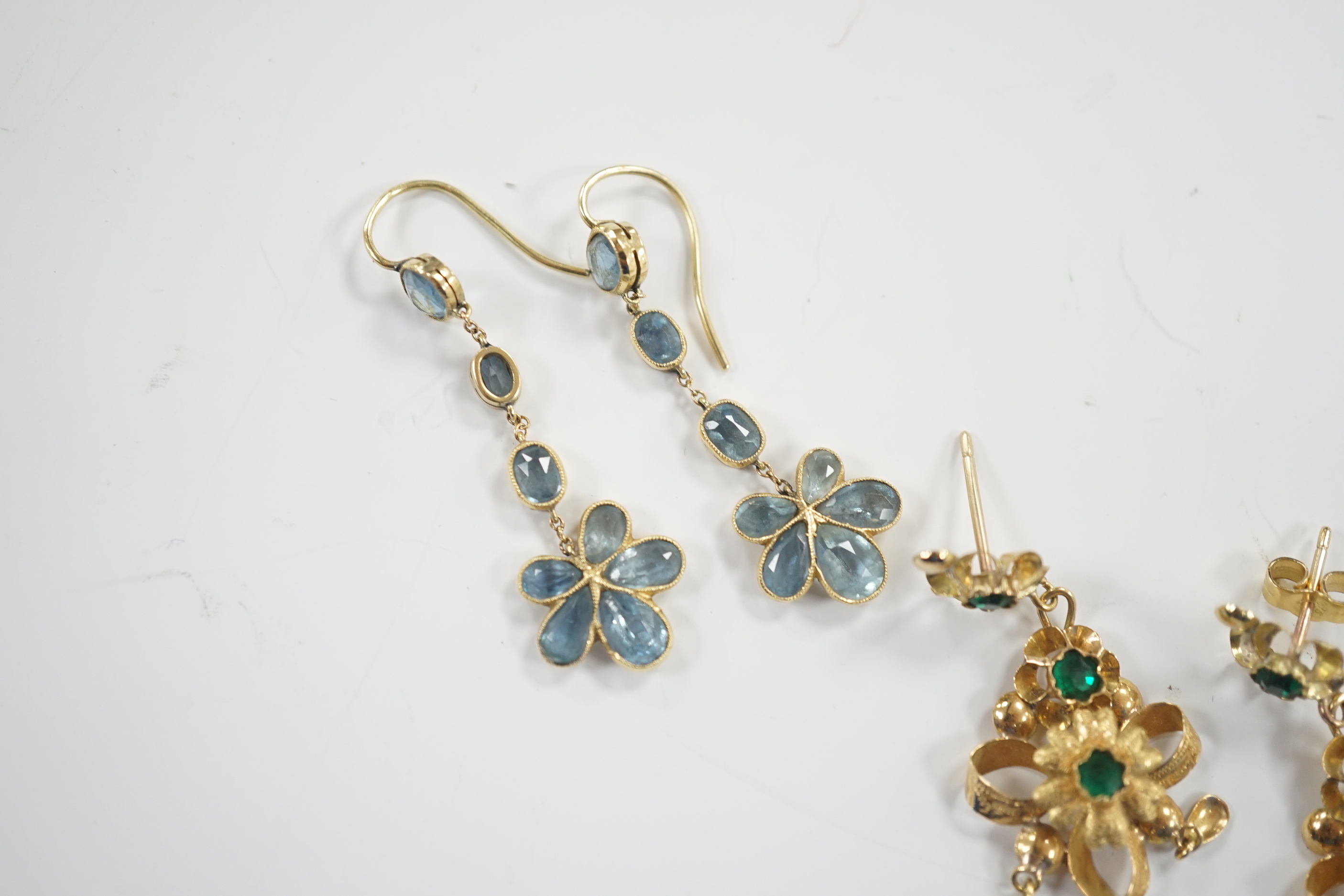 A pair of yellow metal and green paste set drop earrings, 41mm and a pair of yellow metal and aquamarine set cluster drop earrings, gross weight 7.3 grams.